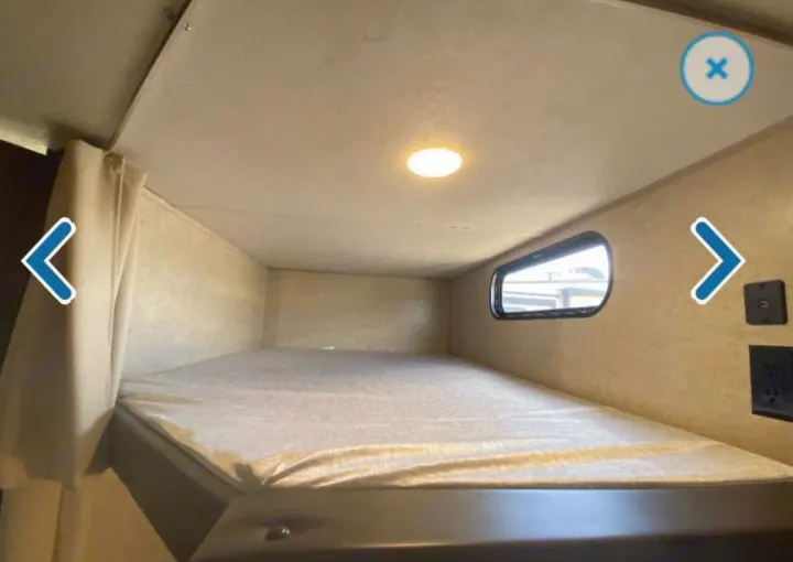 Inside this RV rental, discover a compact sleeping bunk with a window, ceiling light, and power outlets.. Forest River Cherokee 2018