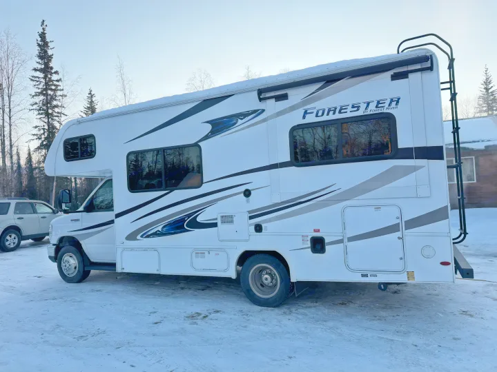 A white Forester RV rental is parked on snowy ground with trees in the background, ready for winter travel or camping.. Forester Forester Motorhome 2020