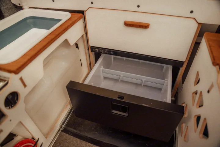 RV rental: Compact kitchen featuring a small sink with water and an open drawer refrigerator for convenience.. Renault TRAFIC 2022