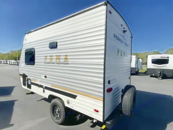 Puma Camping Edition RV rental: A compact white travel trailer with a spare tire, ready for your next outdoor adventure.. Forest River Puma 2025