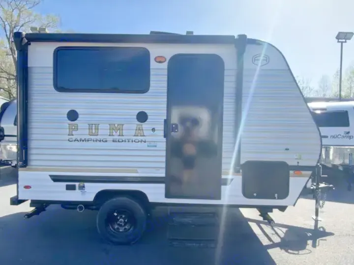 Explore the outdoors with this PUMA Camping Edition travel trailer, a compact and stylish RV rental.. Forest River Puma 2025
