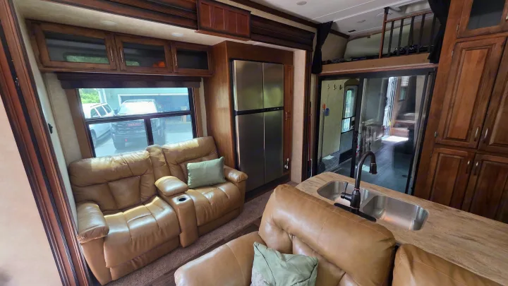 Comfortable RV rental interior: living area with recliners, kitchen sink, fridge, and cozy sleeping loft.. Keystone RV Raptor Toy Hauler 2015