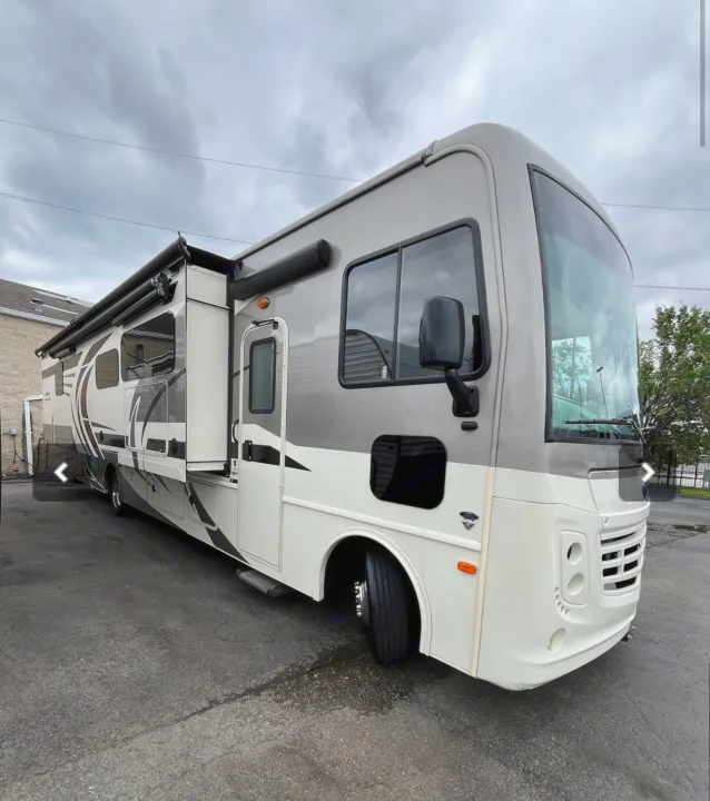This spacious grey and white RV rental motorhome, with an extended slide-out and awnings, awaits your next adventure.. Holiday Rambler Admiral 2021