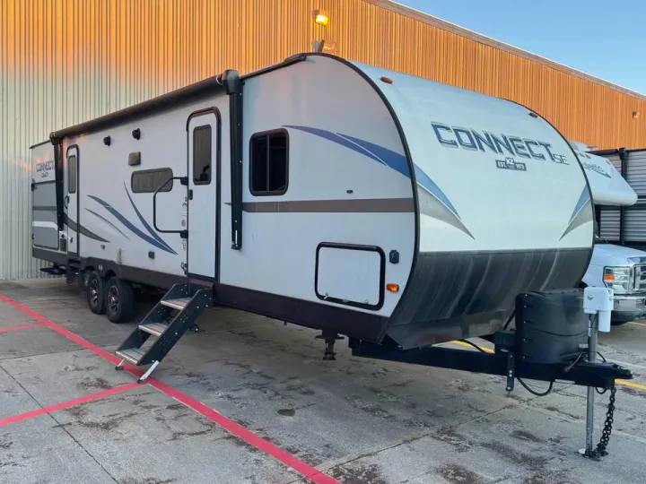 White K-Z Connect SE travel trailer rv rental, parked outdoors. Steps are down, awning extended, front hitch visible.. KZ Connect SE 2021