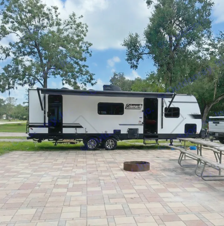Coleman RV rental at a scenic campsite with a picnic table & fire pit. Perfect for your next outdoor adventure.. Keystone RV Coleman Light 2025