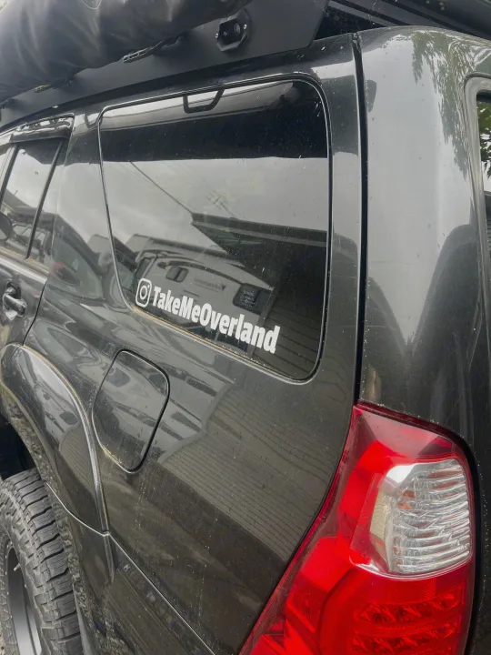 Dusty black SUV with "TakeMeOverland" sticker, rooftop tent, and off-road tires, ready for adventure or rv rental trips.. Toyota 4runner 2006