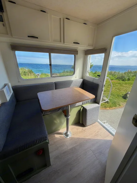 Inside this cozy RV rental: a comfortable dinette with stunning ocean views. Ideal for travel and scenic adventures by the coastline.. Chevrolet Silverado 2500HD 2008