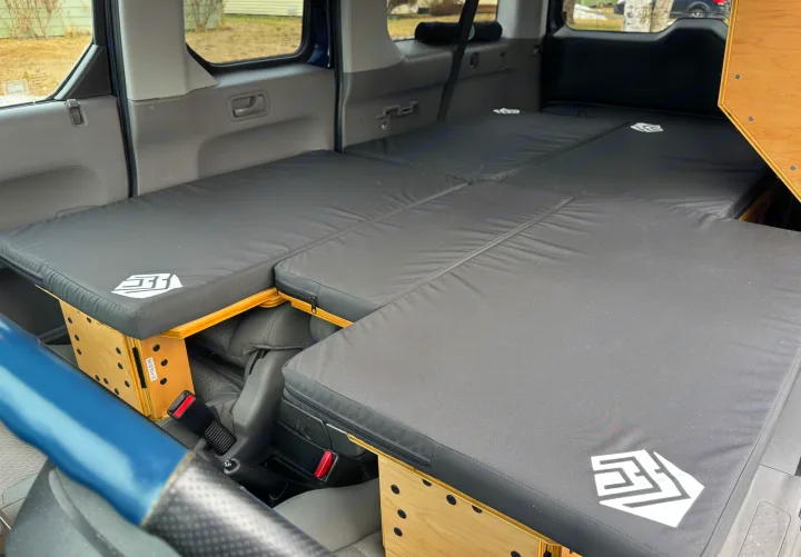 Honda Element camper bed conversion for comfortable car camping or an RV rental alternative. Black mattresses, wooden supports.. Honda Element 2010