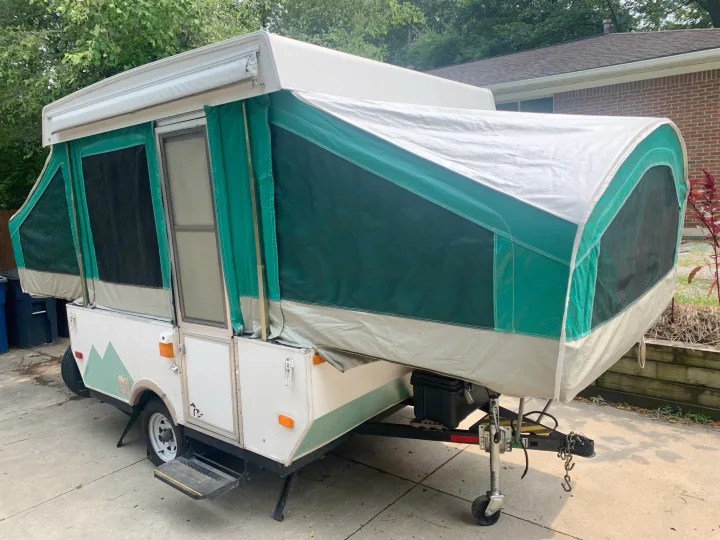 This white and green pop-up camper is fully set up, ready for your next RV rental adventure.. Viking Pop Up 2004