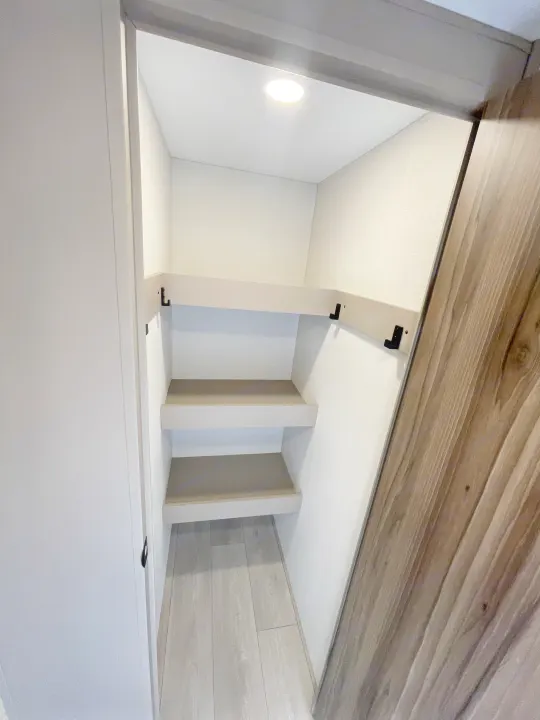 Bright rv rental pantry or closet features three light shelves, LED ceiling light, and wood-look floor for convenient storage.. KZ CONNECT 271BHSE 2026