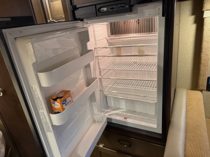 Spacious, clean Norcold refrigerator inside an RV rental, prepped for your journey.. Thor Freedom Elite 2017