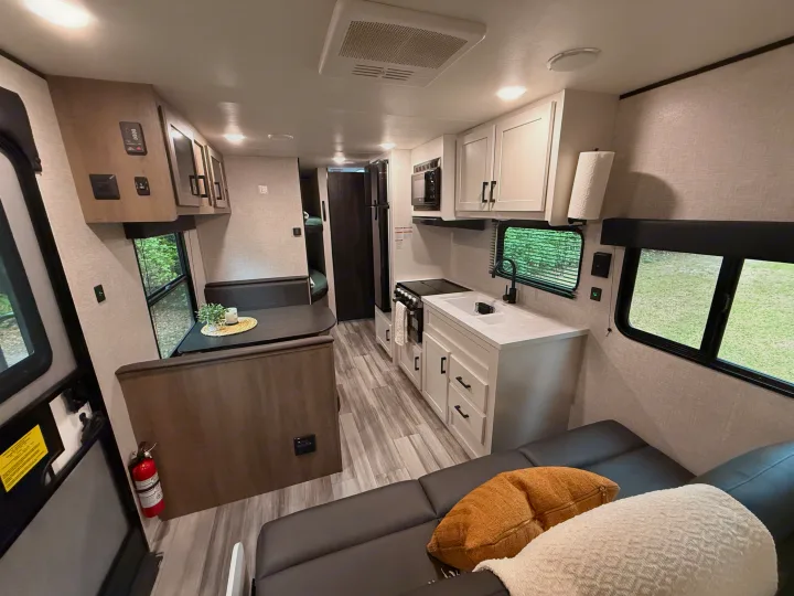 Spacious rv rental interior: bright kitchen, dining booth, and comfy sofa. Modern design for comfortable travel.. Jayco Jay Flight SLX 2024