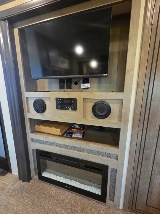 RV rental entertainment center: Vizio TV, RV Technologies stereo, Kenwood speakers, and Greystone electric fireplace.. Forest River Palomino Puma 2020