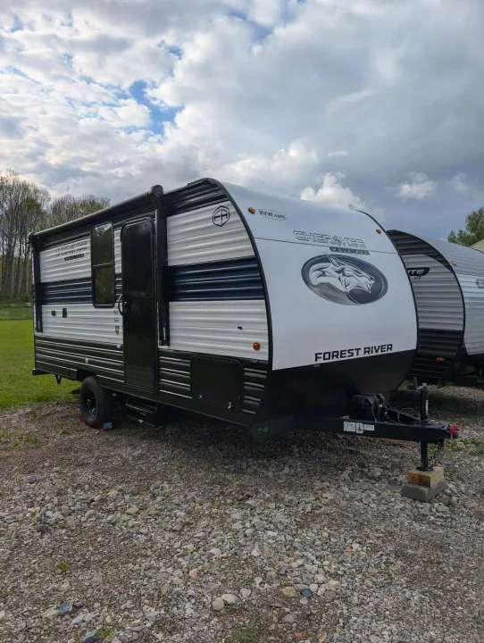 Forest River Cherokee Wolf Pup travel trailer, ideal for your next RV rental adventure, parked on gravel under a cloudy sky.. Forest River Cherokee Wolf Pup 2025