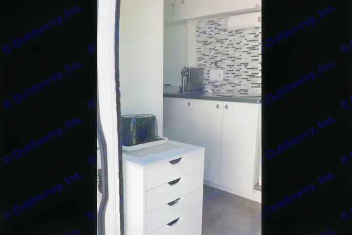 Cozy RV rental kitchenette featuring a mosaic backsplash, coffee maker, toaster, and storage.. RAM Dodge Promaster 2015