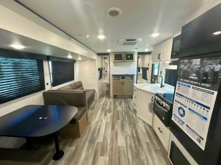 Spacious RV rental interior with a modern kitchen, dining booth, and comfortable living area. Ideal for your next camper adventure.. Jayco Jay Flight 2026