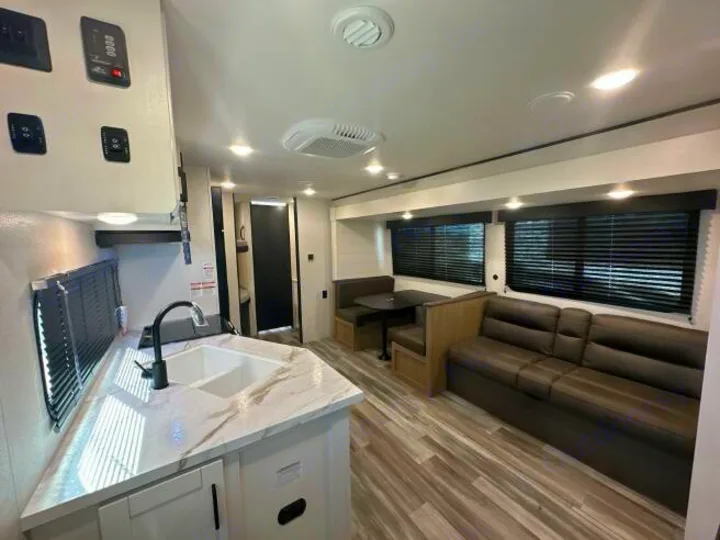 RV rental with modern kitchen, dinette, sofa, wood floors & blinds. Comfortable interior for travel.. Jayco Jay Flight 2026