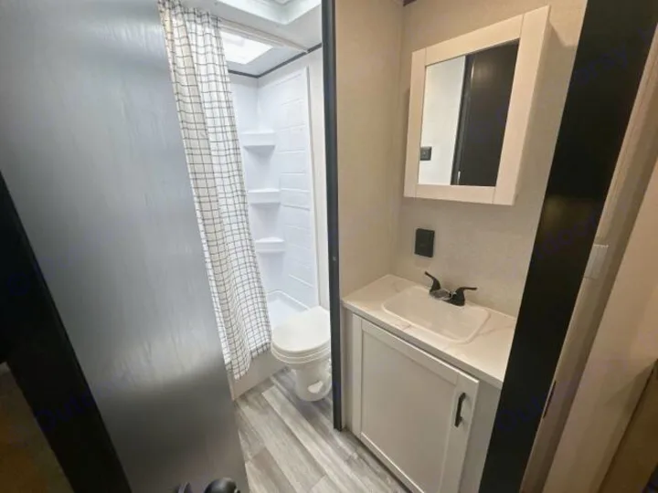 Compact RV rental bathroom with shower, toilet, and sink vanity. Perfect for your travel trailer adventures.. Jayco Jay Flight 2026