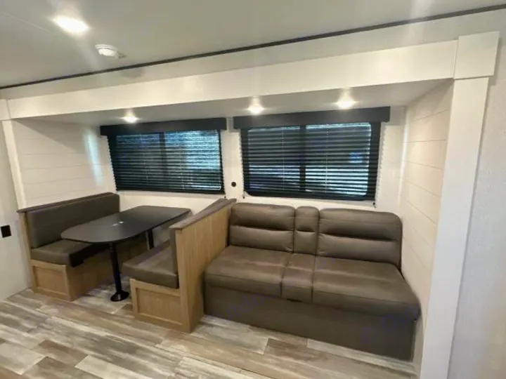 This modern RV rental offers a comfortable dining booth, table, and an adjacent sofa for versatile seating.. Jayco Jay Flight 2026