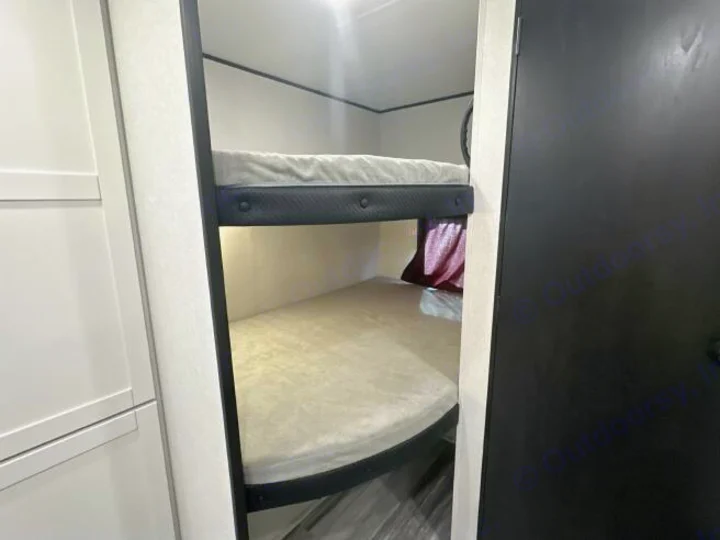 RV rental interior features bunk beds with dark frames & light mattresses, offering a compact sleeping area for travelers.. Jayco Jay Flight 2026
