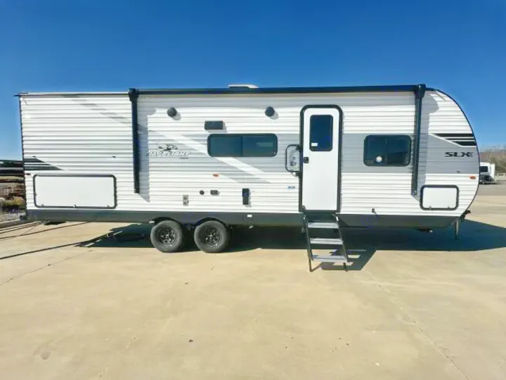 A sleek white and gray Jay Flight SLX travel trailer, perfect for your next rv rental adventure. Parked on concrete.. Jayco Jay Flight 2026