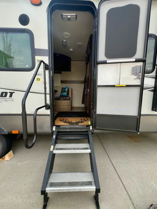 Open RV rental door and steps, revealing the interior with seating. Ready for your next journey.. Crossroads Sling Shot 2012