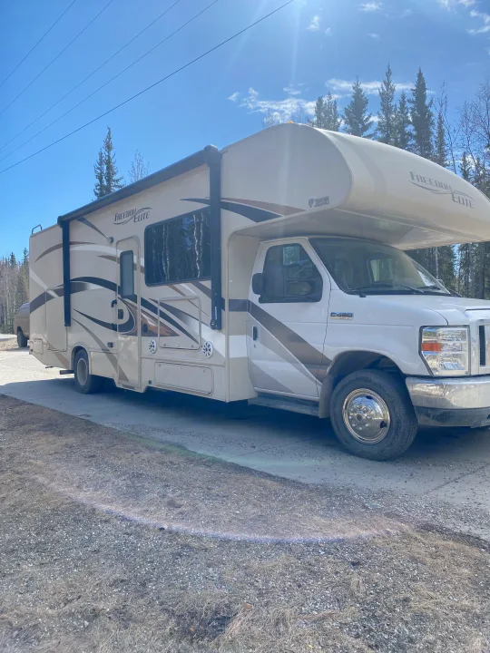 This Thor Freedom Elite rv rental is parked on a sunny day, ready for adventure amidst trees.. Thor Freedom Elite 2016