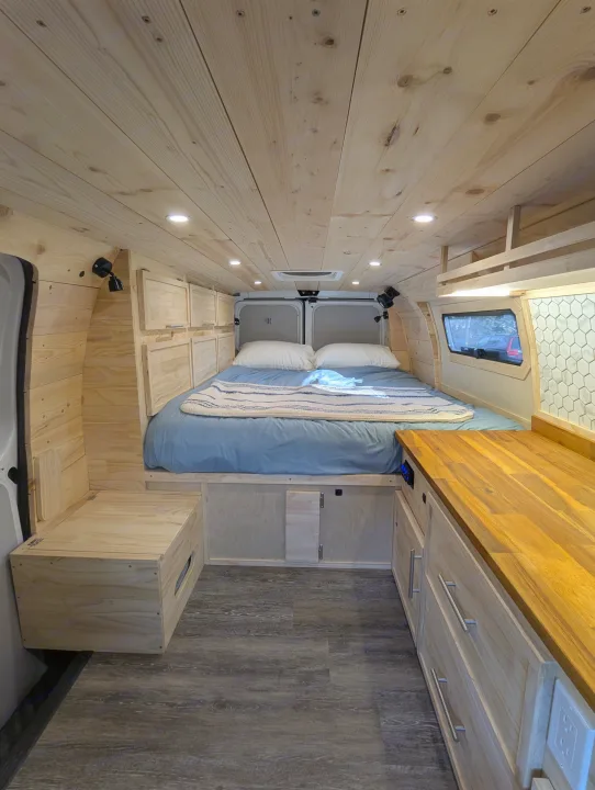Experience a cozy RV rental in this custom camper van. Features a full bed, warm wood interior, and functional storage space.. Gmc Savanna 2500 EXT 2016
