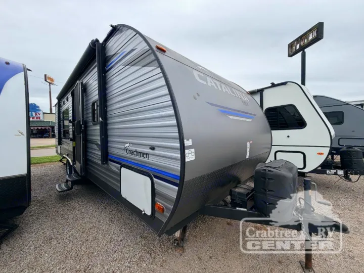 Gray Coachmen Catalina travel trailer, an excellent rv rental or camper option with an extended awning and front hitch.. Coachmen Other 2020