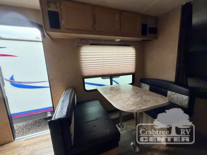 This RV rental's dinette area features a table, two benches, and overhead cabinets, ideal for dining & relaxing.. Coachmen Other 2020