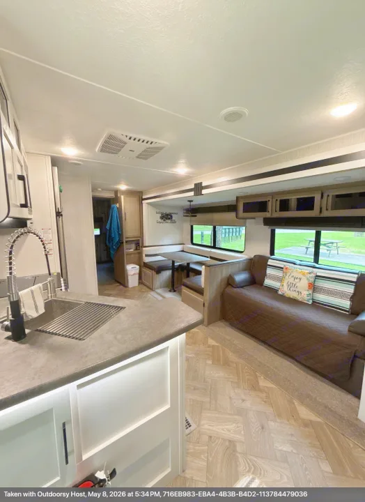 Explore this RV rental's inviting interior: full kitchen, dining booth, and sofa, ready for your next adventure.. Forest River Palomino Puma 2022