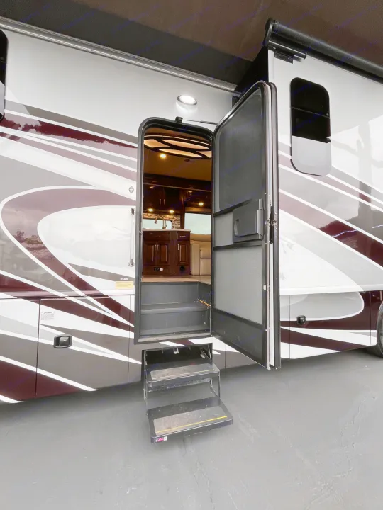Discover this luxurious RV rental motorhome! Its open door, extended steps, and detailed interior are ready for adventure.. Fleetwood Pace Arrow 2020