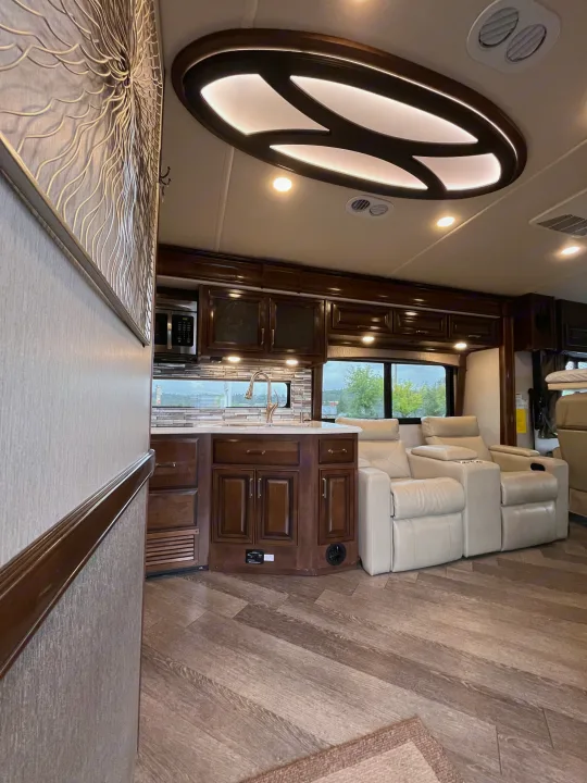 Explore this modern rv rental's interior: a full kitchen, comfortable recliners, and stylish ceiling accents await.. Fleetwood Pace Arrow 2020