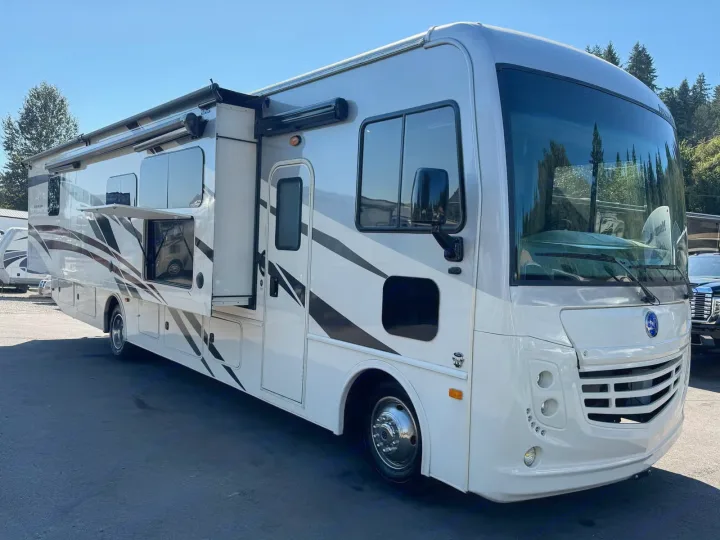 Sleek white RV rental motorhome with gray/black stripes & open slide-out. Perfect for your next road trip adventure.. Holiday Rambler Admiral 2019