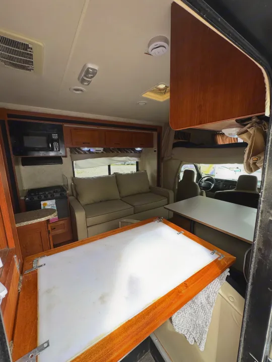 Experience comfortable travels in this RV rental's spacious interior, featuring a kitchen, dinette, and cozy bunk.. Coachmen Freelander 2014