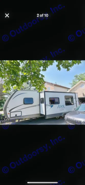 This Apex travel trailer rv rental features an extended slide-out for extra space, parked outdoors on a sunny day.. Coachmen Apex 2017