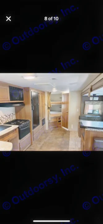 RV rental interior featuring a full kitchen with microwave & stove, dinette, and rear bunk beds, ideal for family trips.. Coachmen Apex 2017