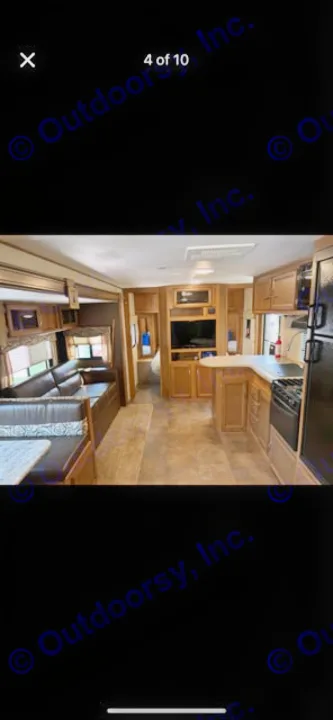 Inside a spacious RV rental: modern kitchen, living area with sofa, dinette, and TV. Perfect for your travel trailer getaway.. Coachmen Apex 2017