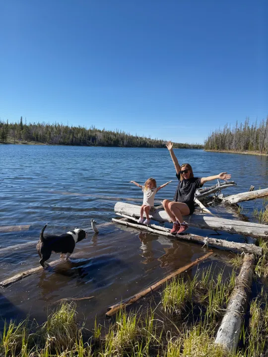 Family and dog enjoying a serene lake day! Perfect for an rv rental adventure in nature with forest views.. International 510A 1973