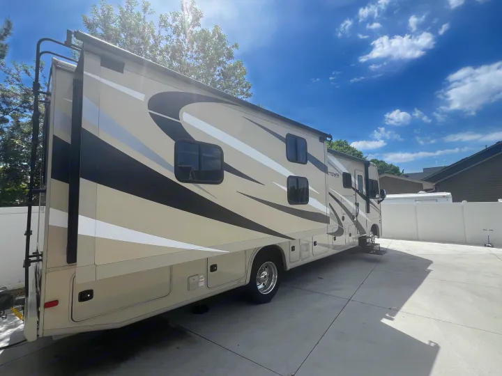 Spacious Class A RV rental, featuring a tan, black, and white exterior, parked on a sunny day. Perfect for your next adventure.. Georgetown GT3 2020