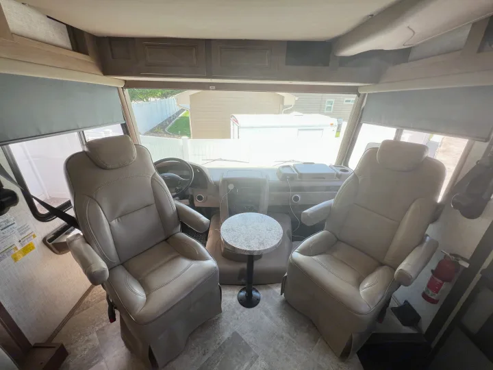 RV rental driver's area: two comfortable captain's chairs, small table, dashboard, and overhead storage. Ready for adventure!. Georgetown GT3 2020