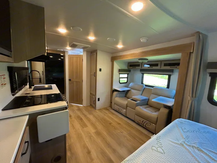 Inside this modern rv rental: kitchen, two recliners, and a cozy 'Bamboo' bed, perfect for your next adventure.. Forest River Rockwood Mini Lite 2025