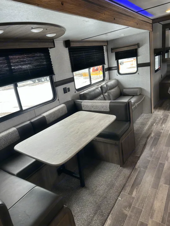 Spacious RV rental interior with a comfortable dinette and sofa, ideal for relaxing on your next adventure.. Crossroads RV Zinger 2021