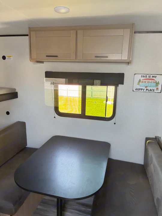 Bright RV rental interior with a dinette, overhead cabinets, and bunk beds, offering a cozy space for your travels.. Jayco 1UJBC0AJ6F7750334 2026