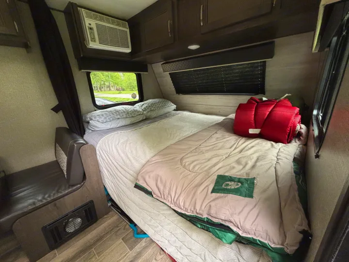 Inside an RV rental: a compact bedroom with AC, storage, and a comfy bed. Ready for your trip!. Jayco Jay Flight SLX 2021