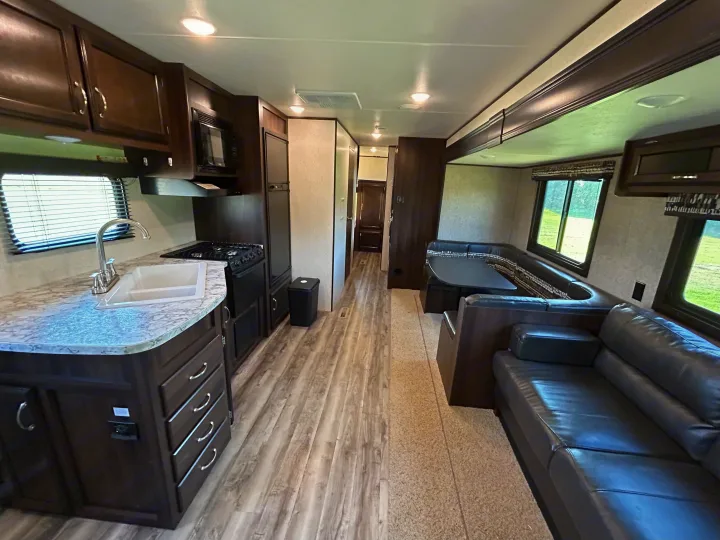 Clean rv rental interior featuring a full kitchen, dinette, and comfortable sofa seating. Ready for your journey!. Jayco Jay Flight SLX 2018
