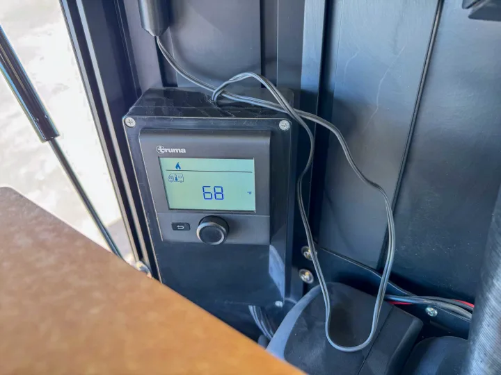 Black Truma RV thermostat shows 68°F, controlling camper climate. Essential for your RV rental comfort.. Toyota Tacoma 2026