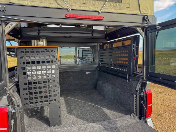 RV rental adventure truck: Organized truck bed with modular storage, pop-top tent, and BedRug liner for camping.. Toyota Tacoma 2026