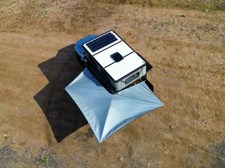 Rooftop tent rv rental: Overland vehicle with solar panel and awning set up on a dirt campsite. Ready for adventure.. Toyota Tacoma 2026