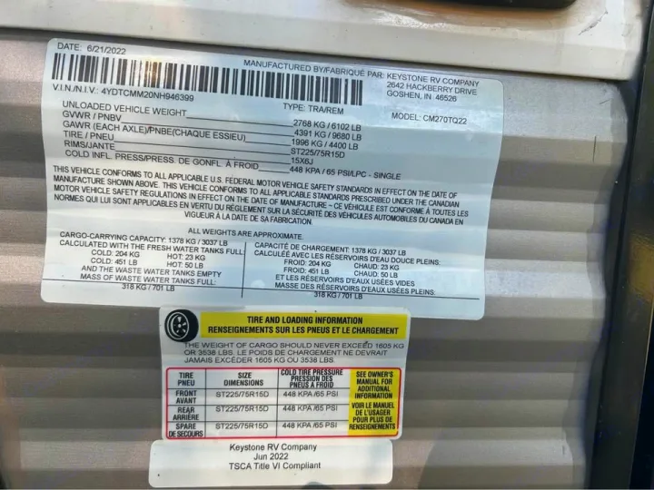 RV rental compliance label with VIN, weight ratings, and tire pressure specs. Crucial safety info for travelers.. Coleman 270TQ 2022